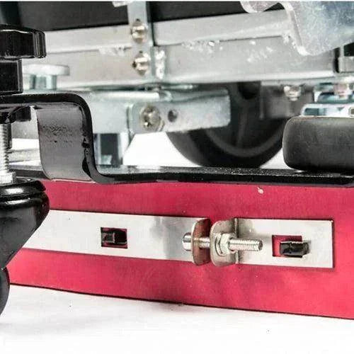 Close-up of the RT50AC walk-behind commercial floor scrubber's underside showing metal components and brush assembly for durable, efficient cleaning.