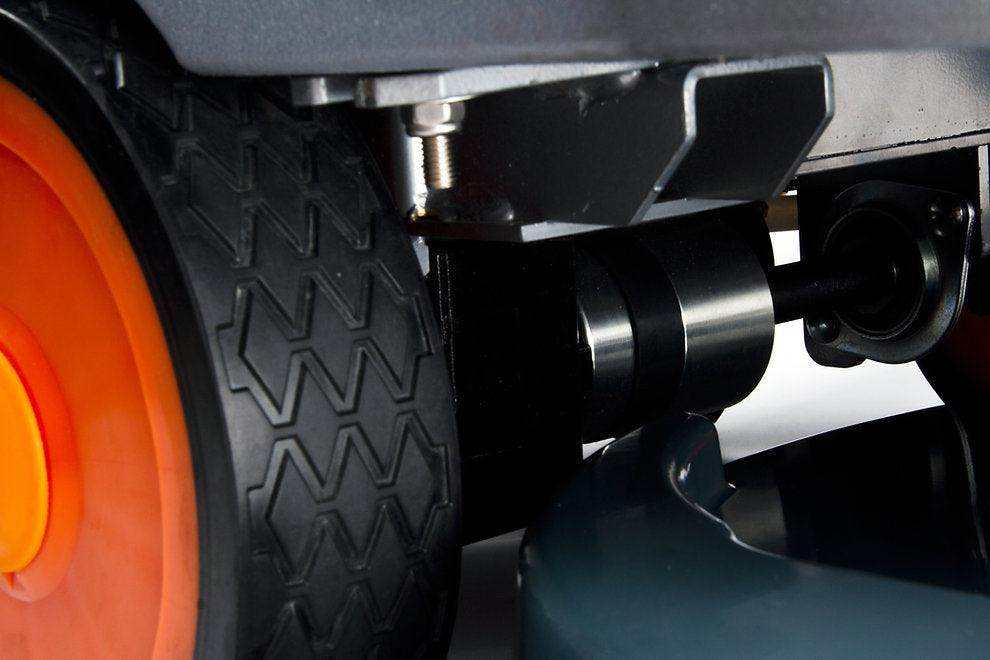 Close-up of RT50D+ Self-Propelled floor scrubber black rubber wheel and metal components with orange hub